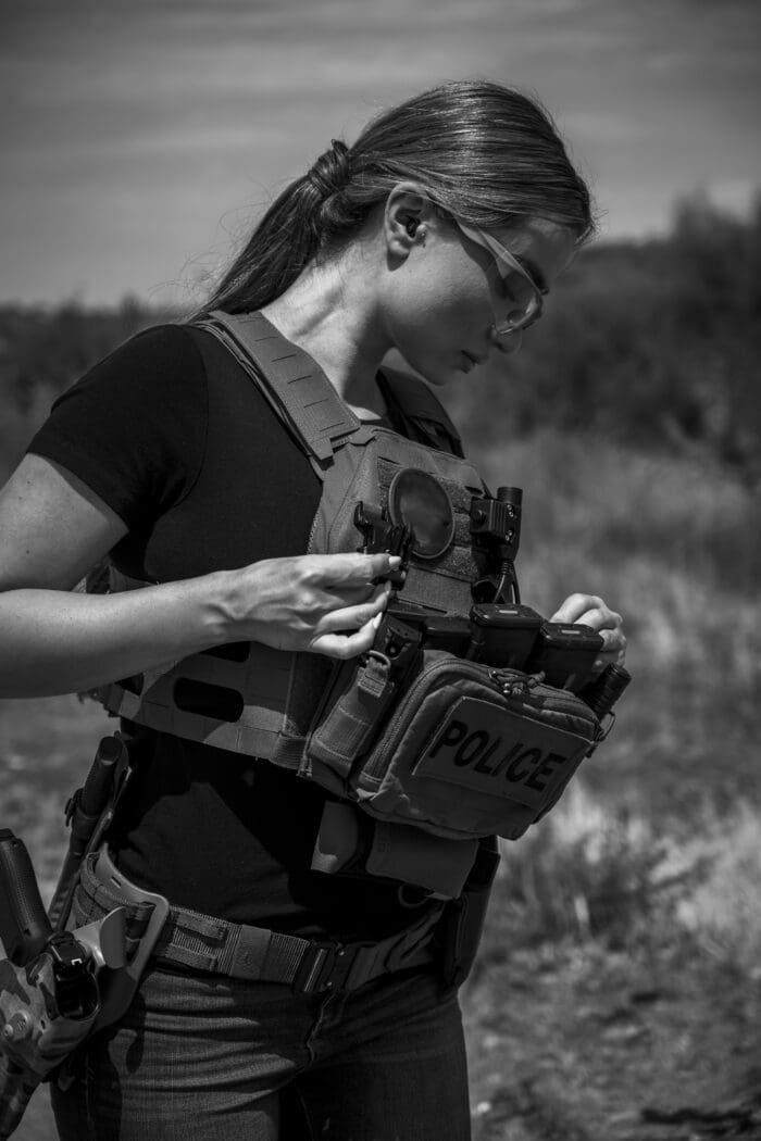 A Woman wears RMA 1118 Level IV plates in a QPC plate carrier.