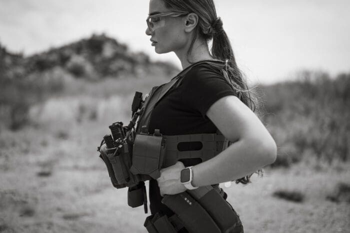 A woman wears FSAPI female body armor RMA 1118 Level IV plates in a QPC plate carrier.