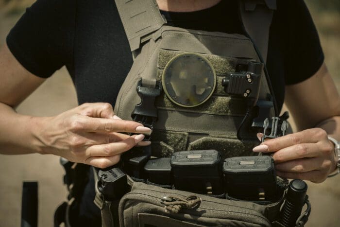 A women customizes her female body armor loadout with a Haley Strategic Micro Rig over RMA FSAPI plates in a QPC.