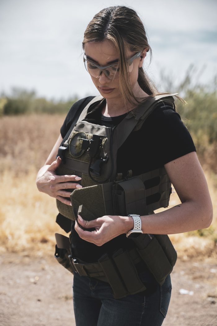 A woman wears RMA 1118 Level 4 Plates in a QPC women's plate carrier.